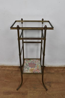Lot 1263 - Glass three tier occasional table, on splayed supports, 60cm high