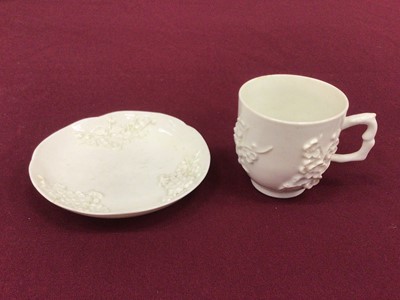 Lot 56 - Bow blanc de chine cup and saucer, circa 1752, decorated in relief with prunus blossom, crabstock handle, the saucer 11.5cm diameter