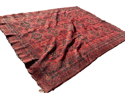 Lot 1430 - Large Eastern rug on red ground, previously purchased from Harrods