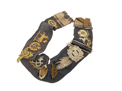 Lot 733 - Collection of 11 Second World War era cap badges mounted on stable belt.
