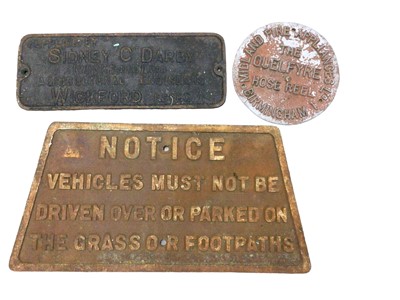 Lot 91 - Group of four  relief cast metal signs, including one for 'Sidney C Darby' agricultural engineers, Wickford, one for 'The Quelfyre Hose Reel', and one other vehicle notice (3)