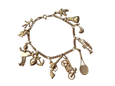 Lot 21 - 18ct gold charm bracelet with eleven 18ct gold novelty charms