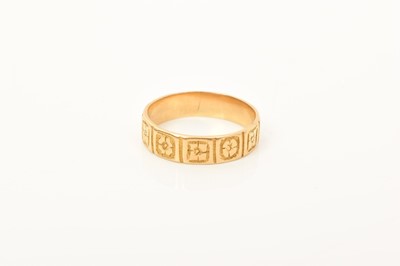 Lot 589 - Victorian 18ct gold ring, the band with square panels depicting engraved flower heads (London 1863)