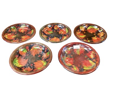Lot 1163 - Set of five Moorcroft plates decorated with the Flambe Leaves pattern