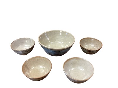 Lot 1175 - Suite of Leach St Ives pottery bowls, including larger bowl, 22cm diameter and set of four, all abstract band ornament