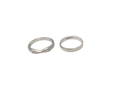Lot 117 - 18ct white gold band set with two brilliant cut diamonds and an 18ct white gold wedding ring (2)