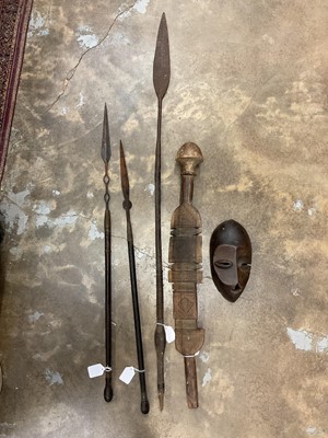 Lot 2428 - Tribal Art - a Tuareg tent peg, carved with bands of geometric motifs, together with three antique African spears and a tribal face mask (5)