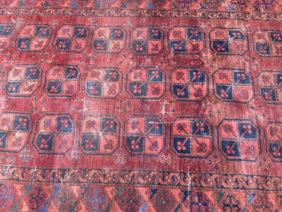 Lot 1438 - Antique Persian design rug with geometric medallions on dark red ground
