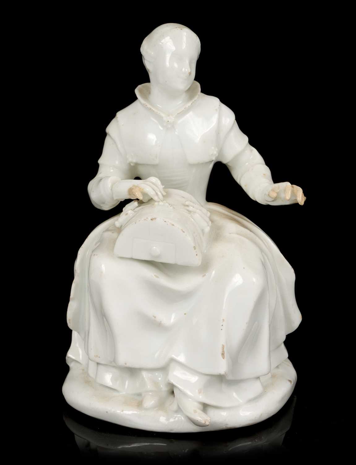 Lot 60 - White glazed porcelain figure of a lacemaker