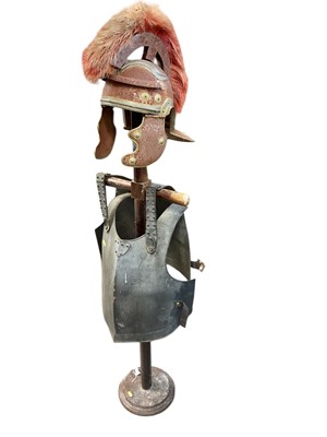 Lot 805 - Reproduction Roman style helmet and breast plate on wooden stand.
