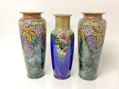 Lot 1260 - Pair of Royal Doulton vases with fruit and leaf decoration and another similar (3)