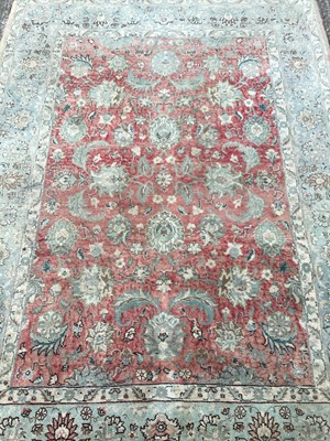 Lot 1451 - Rug with floral decoration on red and pale blue ground, 200cm x 145cm