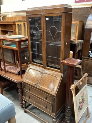 Lot 1482 - Oak bureau bookcase with leaded glazed doors above, writing compartment and two drawers below