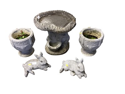 Lot 1496 - Concrete garden bird bath, 40cm wide, 38cm high, together with a pair of concrete urns, 25cm high, and a pair of concrete rabbits, 17cm high (5)