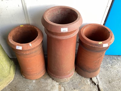 Lot 1515 - Three terracotta chimney pots, 64cm high and the other two are 47cm high