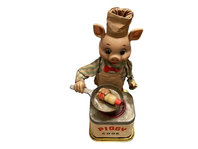 Lot 1921 - Automaton Piggy Chef tin plate and plastic plus tin plate and fabric automaton clockwork monkey with mirror.