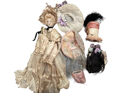 Lot 1922 - Victorian handmade fabric fashion dolls, in period dress and accessories. white kid leather lower legs, stitched features. Plus small German bique doll head.
