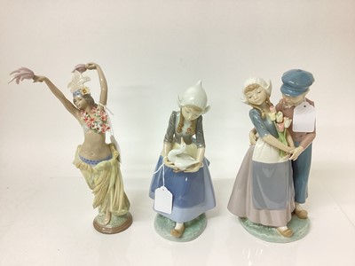 Lot 1196 - Three Lladro porcelain figures - semi clad dancer, 29cm high, Dutch couple and Dutch girl with goose