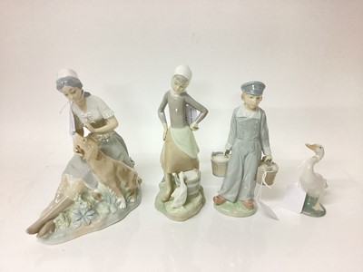 Lot 1199 - Two Lladro porcelain figures, Lladro goose and a Nao figure of a lady with dog (4)