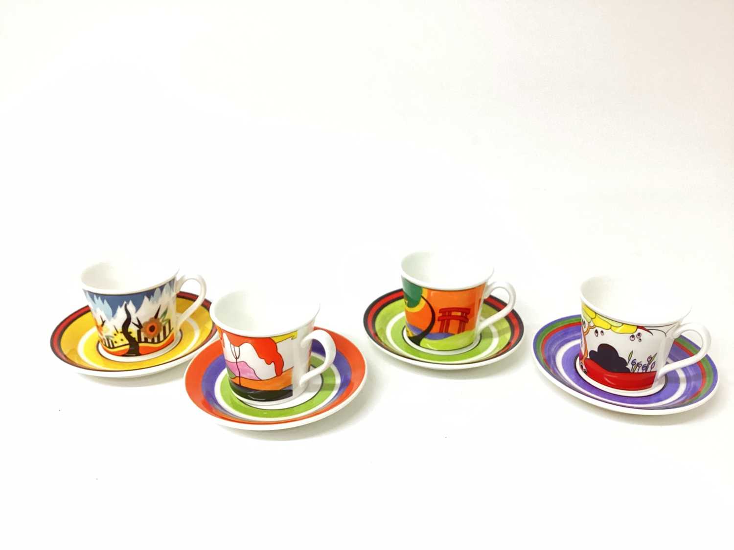 Lot 1203 - Seven Wedgwood Clarice Cliff limited edition Cafe Noir cups and saucers - Red Autumn, Tulip, Monsoon, Garden Blue, Fantasque Mountain, Windbells and Blue Lucerne, together with another saucer - Cor...