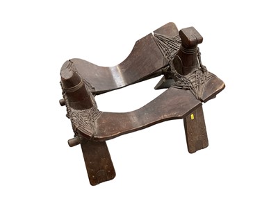 Lot 2540 - Early saddle possibly Tibetan or Chinese, together with a pair of stirrups