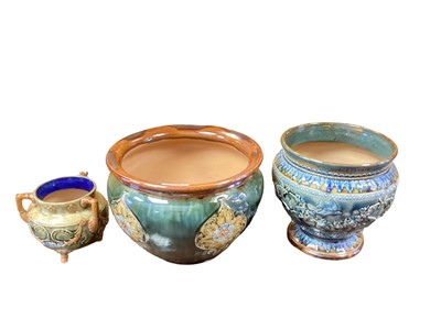 Lot 1261 - Doulton Lambeth stoneware jardinière decorated with birds and foliage, 19cm high, together with a Royal Doulton jardiniere with Art Nouveau decoration, 18cm high, and a three handled vase (3)