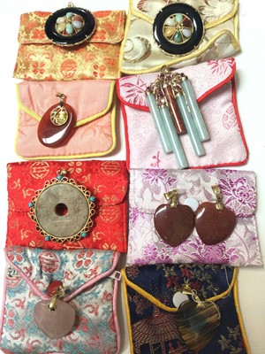 Lot 168 - Nine pendants including Chinese jade/ green hard stone, rose quartz, tiger's eye etc, all in 14ct gold/ yellow metal mounts
