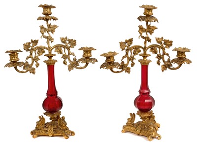 Lot 975 - Pair of 19th century ormolu and ruby glass three branch candelabra