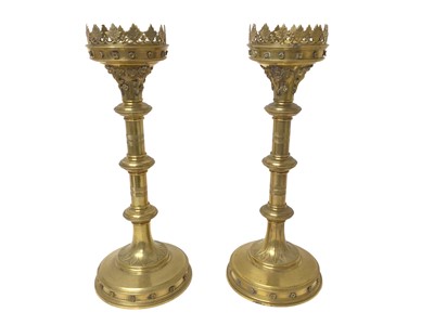 Lot 981 - Pair of gothic brass alter candlesticks