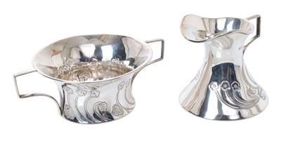 Lot 323 - Edwardian Art Nouveau silver milk jug and sugar bowl, each with stylised floral decoration