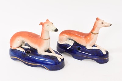 Lot 227 - Two 19th century Staffordshire recumbent greyhound inkwells