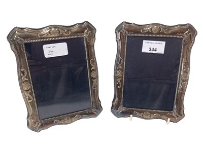 Lot 344 - Pair contemporary silver photograph frames of vertical, shaped rectangular form