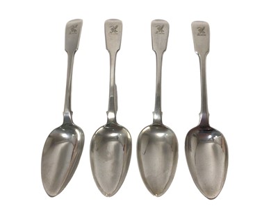 Lot 393 - Set of four Georgian Fiddle pattern table spoons with engraved armorial crests