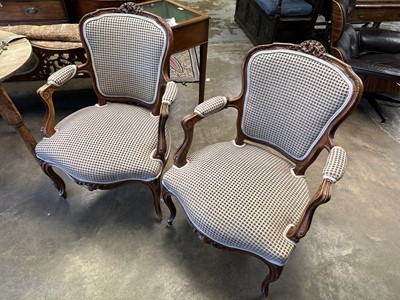 Lot 1504 - Pair of Louis XVI style carved walnut open arm chairs