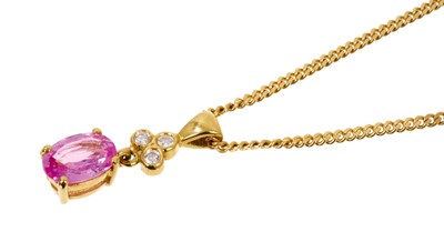 Lot 546 - Pink sapphire and diamond pendant necklace with an oval mixed cut pink sapphire measuring approximately 7 x 5 x 2.7mm surmounted by three brilliant cut diamonds in 18ct gold setting on 18ct gold ch...