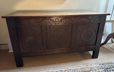 Lot 1485 - Antique oak coffer, earlier elements, with carved three panelled front, on black feet, 113cm wide x 51cm deep x 61cm high