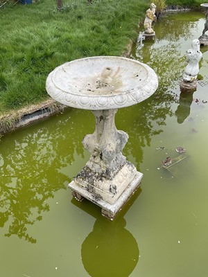 Lot 1559 - Old reconstituted stone garden fountain with circular bowl on pedestal base with lions to each corner on square base.