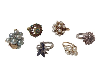 Lot 589 - Group of six 1960s/1970s gold and multi-gem set cocktail rings to include a sapphire and diamond cluster ring, a turquoise and ruby cluster ring, three cultured pearl cluster rings and a white ston...