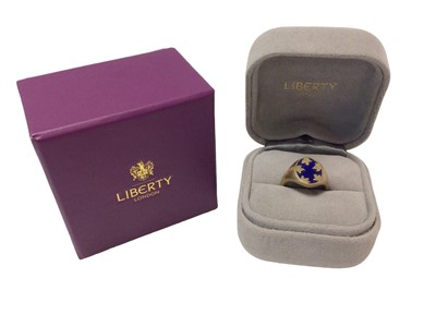 Lot 586 - Liberty gold and lapis lazuli signet ring with an oval bezel inset with a lapis lazuli plaque and gold mounts on textured gold shank, signed Liberty, hallmarked London 2020. In original Liberty rin...