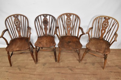 Lot 1534 - Three similar 19th century ash and elm wheel back Windsor elbow chairs and a similar side chair, each with saddle seat on turned legs and H-stretcher