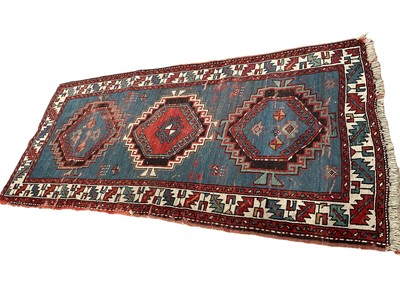 Lot 1575 - Small Caucasian rug, having three serated medallions on powered blue ground, 198 x 91cm