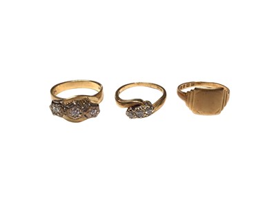 Lot 25 - Two 18ct gold diamond three stone cross over rings and an 18ct gold signet ring (3)