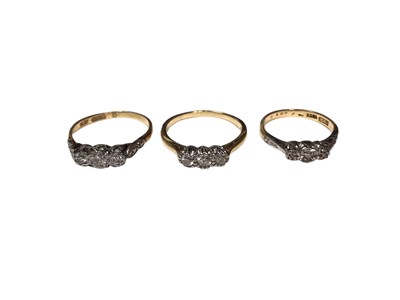 Lot 27 - Three 18ct gold diamond three stone rings in platinum settings