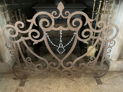 Lot 1155 - Pierced iron fire guard, 105cm wide, together with a large woven log basket, other items