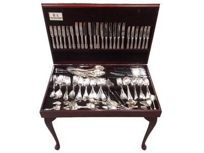 Lot 372 - Extensively fitted canteen of cutlery, the mahogany canteen with inset green tooled leather top on cabriole legs, 76cm wide, housing a large quantity of various cutlery