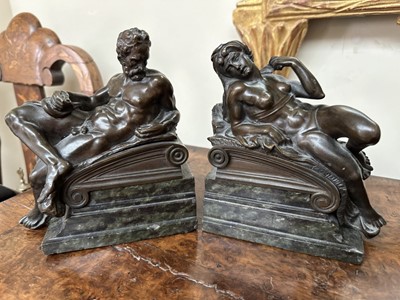 Lot 1527 - Pair of bronze bookends after Michaelangelo