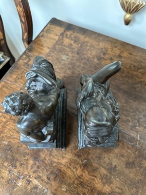 Lot 1527 - Pair of bronze bookends after Michaelangelo