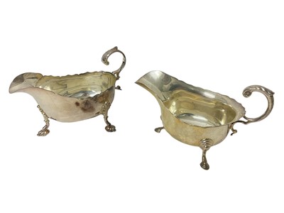 Lot 1631 - Two similar silver sauceboats