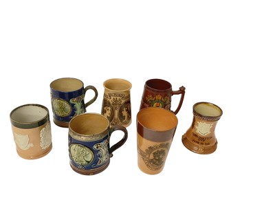 Lot 124 - Collection of seven late 19th/early 20th century Royal Doulton stoneware Royal Commemorative mugs and vessels including silver mounted mug (7)