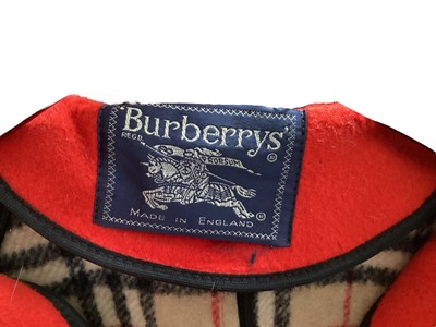 Lot 2076 - Burberrys' red duffle coat with check interior and toggle fastenings, label size 20, Escada yellow wool mix zip front coat, size 36, Robinson's California cream tweed coat with white fox fur collar...